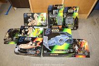 All Star Wars collectible items displayed together on floor showing original packaging and variety of characters and vehicles from 1995-1998.