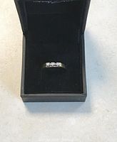 Ring displayed in open black Thomas Sabo box on a white surface