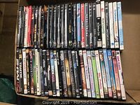 Photo of two stacked rows of 48 DVDs showing spines with varied movie titles.