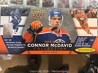 Photo of boxed 2015-2016 Connor McDavid Upper Deck Collection. Box front shows Connor McDavid in hockey gear and advertises 25 cards and some autographed cards plus an authentic super-patch card.