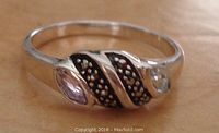 Front view of the sterling silver ring showing amethyst, aquamarine, and marcasite stones set in oxidized silver pattern
