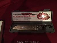 8 inch Santoku knife in original plastic case showing labeling and knife shape