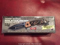 Box of United Military Seek, Attack, Destroy assisted folder new in box, showing brand and key features.