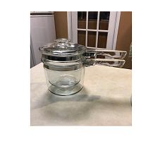 Full assembled view showing larger pot with smaller pot inside and lid on top, arranged to show the double boiler set assembled.