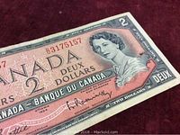 Close-up of the banknote with visible serial number and Queen Elizabeth II portrait