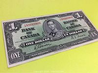 Front angle close-up of a 1937 Canada one dollar banknote showing portrait, serial number, and signatures.