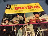 Front cover of the comic book showing characters and Herbie with racing helmets