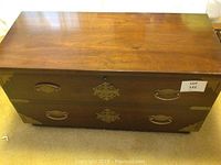 Top view of the wooden cedar chest showing smooth polished wood surface with some wear.
