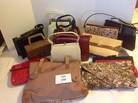 Wide shot showing all 11 vintage womens purses and handbags arranged together