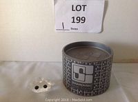 Photo showing the Swarovski branded round box and the frog prince figurine lying flat, highlighting the crystal material and black eyes.