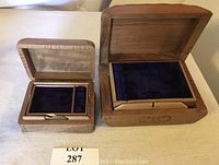 Both trinket boxes shown open to reveal lined compartments inside