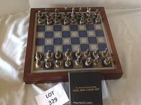 All chess pieces set up on the wooden board viewed from above