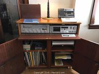 Wood stereo stand front open showing Marantz receiver, Sony cassette deck and vinyl storage