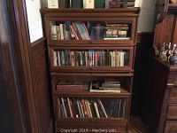 Full view of oak barrister bookcase with books in each tier