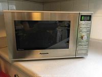 Front view of microwave showing steel exterior and control panel