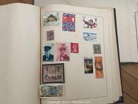 Stamp album page with mixed US and Canadian stamps including fish, Christmas, airplane and historical figures