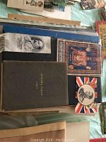 Stack of travel guides and booklets including Niagara Falls 1885 hardcover, Vatican souvenir guide, Walker’s guide and Union Jack souvenir card