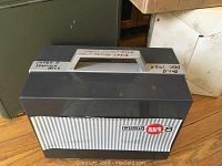 Closed grey plastic carrying case labeled Eumig Mark 8 Super 8mm movie camera.