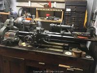 Full view of South Bend lathe on wooden bench showing headstock, carriage and tailstock