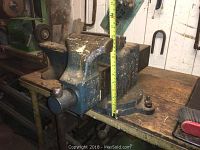 Front view of bench vise showing fixed jaw, moving screw and partial measurement