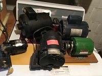 Six assorted small electric motors arranged on table