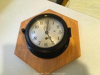 Front view of clock mounted on oak plaque