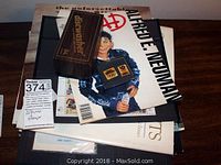 Photo shows various vinyl albums stacked with a vintage Mad Magazine featuring Alfred E. Neuman, and a wooden box labeled Dishwasher.