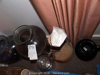 Photo showing two large vintage Spanish glass vases in purple and pink colors, one round with wide opening, tagged with lot number and label.