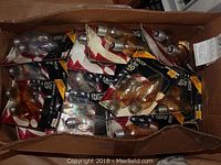 Box containing multiple packs of Sylvania candle shaped light bulbs in original packaging.