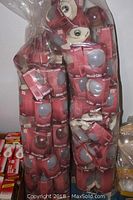 Two plastic bags filled with Mood Glo bulbs in pink packaging visible through clear bag