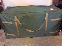 Closed wheeled storage container storing the artificial trees and accessories.