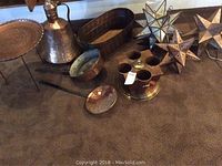 Lot of copper decor items including a wine cooler, small bowl, tray, cup, and perforated discs, as well as star-shaped hanging lights