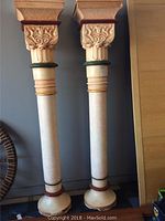 Full view of two large pillars, tall cylindrical shape with wide base, showing color and size