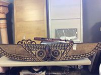 Full view of the large wooden mask showing its length and design