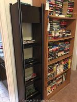 Tall wooden clock with glass shelving containing multiple model train replicas, dark wood finish.