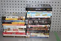 Front view of stacked DVDs showing titles including Johnny Carson Ultimate Collection, Bend It Like Beckham, Shrek 2, Madagascar, and more.