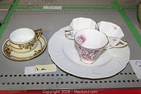 Photo showing three fine bone china tea cups and a Rosenthal plate with embossed white detailing.
