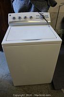 Full front view of Kenmore top load washer showing lid and side profile.