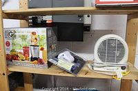 Photo of Honeywell heater, Magic Bullet box and coffee maker on wooden shelf