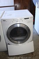 Front view of white Whirlpool Duet washing machine with pedestal base drawer detached