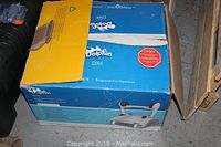 Closed Dolphin DX4 box on floor with yellow flap partially open