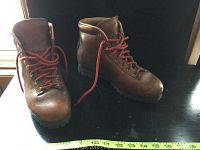 Front and top view of both brown leather boots with red laces showing size and lace-up design.