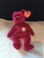 Red Ty Beanie Baby Valentina plush bear with white heart on chest, original Ty tag attached to ear
