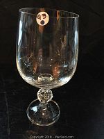 Single Claudia crystal water stemware glass showing clear faceted ball stem, rounded bowl, and circular base