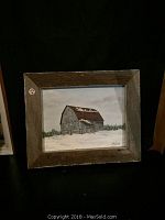 Frontal view of the original acrylic painting depicting a barn in a snowy scene, displayed in a rustic barn wood frame.