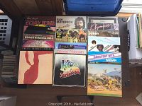 Photo showing top view of multiple LP vinyl record covers featuring various rock and pop artists like KC and the Sunshine Band, Rick James, Earth Wind & Fire, and others.