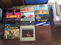 Photo displaying a collection of assorted LP records showing covers of artists such as Gino Vannelli, Elvis Presley, Patsy Cline, Neil Diamond, and others.