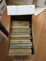 Top view of a box filled with comics packed vertically showing the edges of the comics
