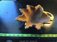 Top view of the carved maple leaf shaped butternut wood bowl with clear details of the leaf lobes and handle, measuring approximately 9 inches wide.
