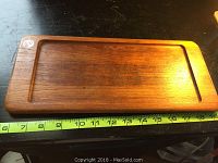 Top view photo showing the rectangular teak tray with visible wood grain and inlaid lip border on all sides, measuring about 14 inches long.